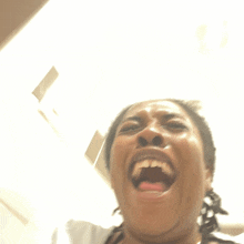 a close up of a woman screaming with her mouth open