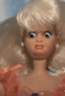 a close up of a barbie doll 's face with a serious look on her face .