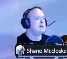 a man wearing headphones and a name tag that says shane mccloske