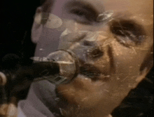 a man singing into a microphone with his face visible