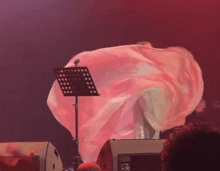 a woman in a pink dress is dancing on stage