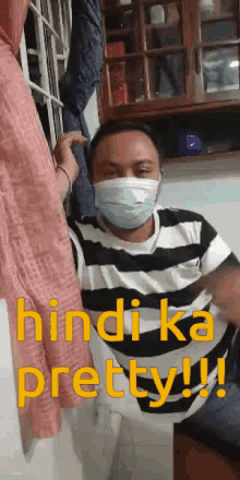 a man wearing a mask and a striped shirt says hindi ka pretty !!