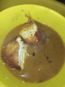 a close up of a bowl of soup with a piece of food missing