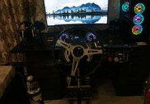 a steering wheel sits on a desk next to a monitor