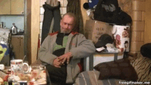 a man is sitting in front of a pile of boxes including one that says ' snoop dogg ' on it