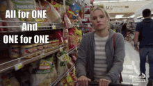 a woman pushing a shopping cart in a grocery store with the words " all for one and one for one " written above her