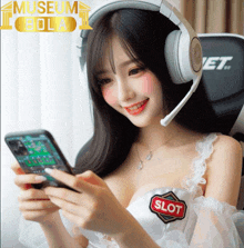 a woman wearing headphones is looking at a phone with a slot patch on her chest