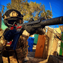 a man holding a rifle with a silencer that says ' assault rifle ' on it