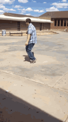 a man in a plaid shirt is skateboarding in front of a sign that says " pick it up "