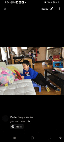 a picture of a boy sitting on a couch with a remix button on the bottom