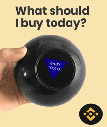 a person holding a magic ball that says baby yolo on it