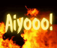 the word aiyoo is lit up in front of a fire background