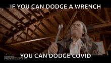 a man is holding a wrench in his hands and says `` if you can dodge a wrench you can dodge covid ''