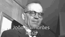 a black and white photo of a man with the name joao guimaraes rosa on the bottom