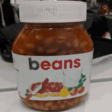 a jar of baked beans has a white label that says beans