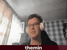 a man wearing glasses and headphones has the name themin on the bottom