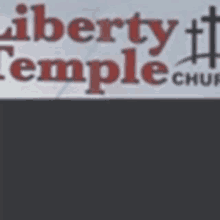 a sign for the liberty temple church is displayed on a gray background .