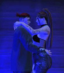 a man and a woman are hugging each other in a blue light