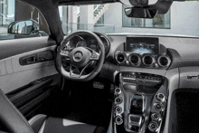 the interior of a mercedes benz sports car with a steering wheel that says amg on it