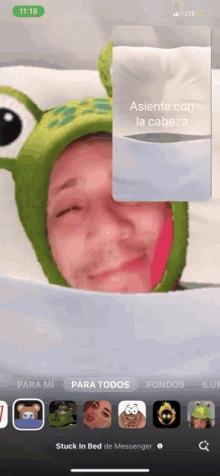 a man wearing a frog hat is laying on a bed in a messenger video