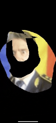 a blurred image of a man in a suit and tie with a flag in the background .