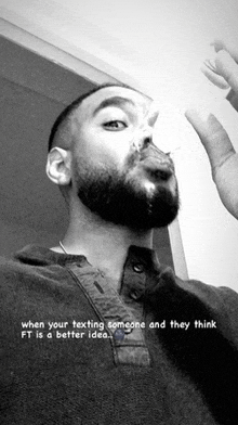 a black and white photo of a man with a beard and a caption that says when your texting someone and they think