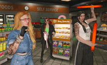 three women are standing in front of a ring donuts stand