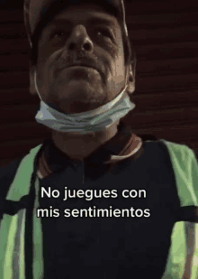 a man wearing a face mask and a safety vest says no juegues con mis sentimientos