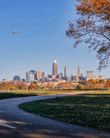 a plane is flying over a city skyline