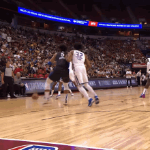 a basketball game is being played in front of a large crowd with a sign that says hello las vegas