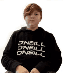 a boy wearing a black hoodie that says o'neill