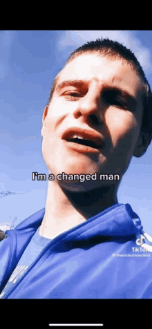 a young man in a blue jacket says " i 'm a changed man "