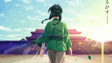 a person in a green kimono is walking in front of a chinese building