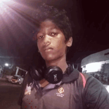 a young man wearing headphones and a shirt that says " white team extreme "