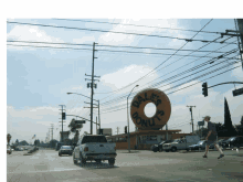 a dale 's donuts sign is in the middle of a busy street