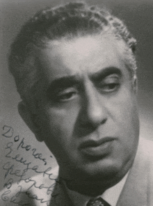 a black and white photo of a man with a hand written note