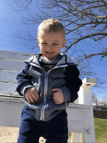 a young boy wearing a jacket that says ck