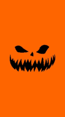 an orange background with a silhouette of a pumpkin face on it