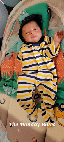 a baby in a yellow and black striped outfit is laying in a crib with the monday blues written on the bottom