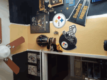 a room with a ceiling fan and a sign that says steelers packers on it