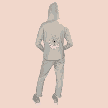 a person wearing a hoodie with a crescent moon and eye on the back