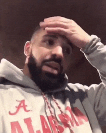 a man with a beard wearing an alabama sweatshirt