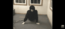 a person is crawling on the floor in a room