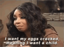 a woman is sitting at a table and talking about eggs cracked , meaning i want a child .