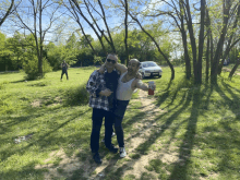 a man in a white tank top holds a can of soda