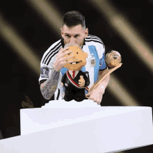 a man with a tattoo on his arm is holding a trophy and a doll