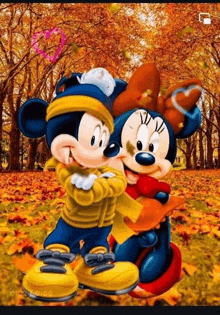 mickey mouse and minnie mouse are hugging each other in a park with leaves falling from the trees .