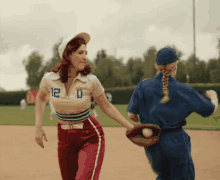 a woman wearing a number 12 jersey holds hands with another woman