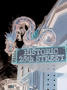 a sign that says historic 25th street with a dragon on it