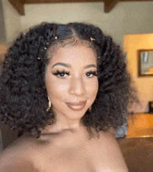 a woman with curly hair takes a selfie